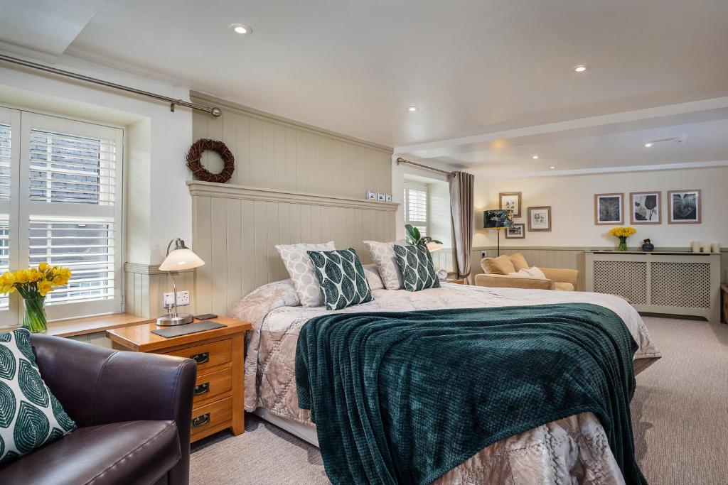 a bedroom with a large bed and a couch at The Coach House Brecon in Brecon