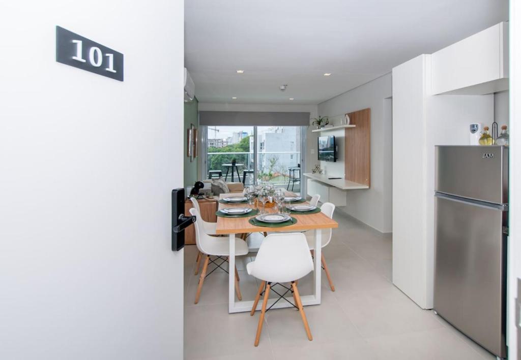 a kitchen and dining room with a table and a refrigerator at Stylish 2BR Apt in Top Location in Asunción