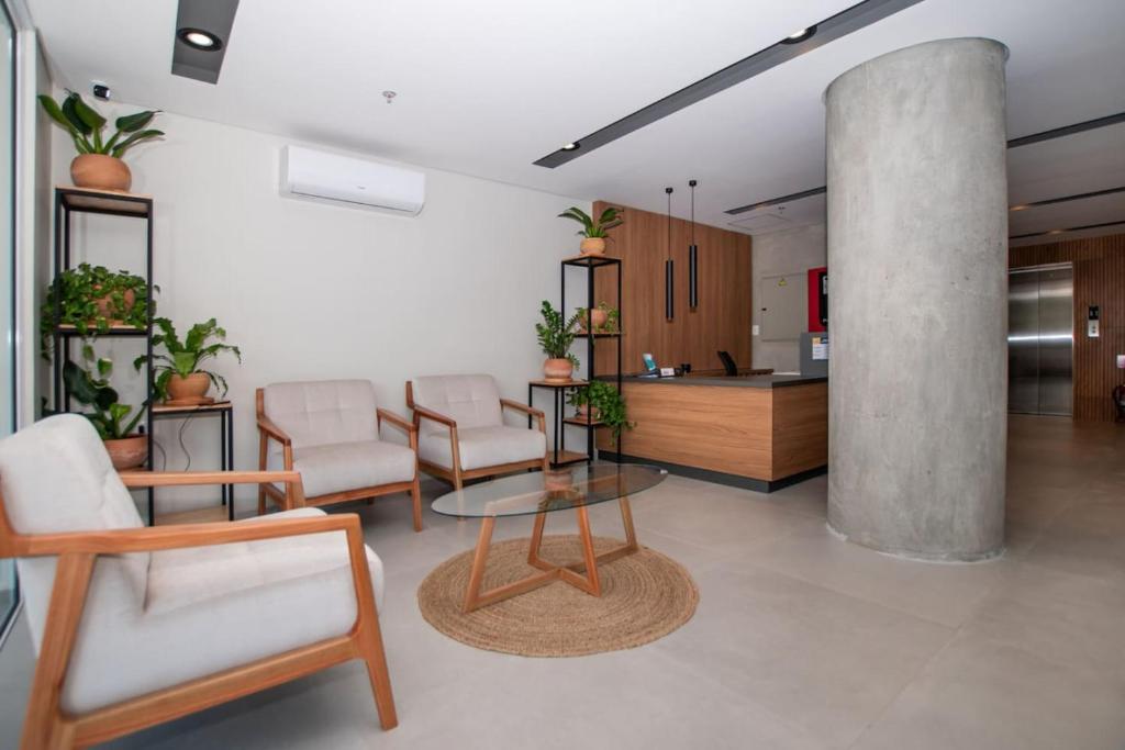 a living room with a table and chairs and a kitchen at Stylish 2BR Apt in Top Location in Asunción