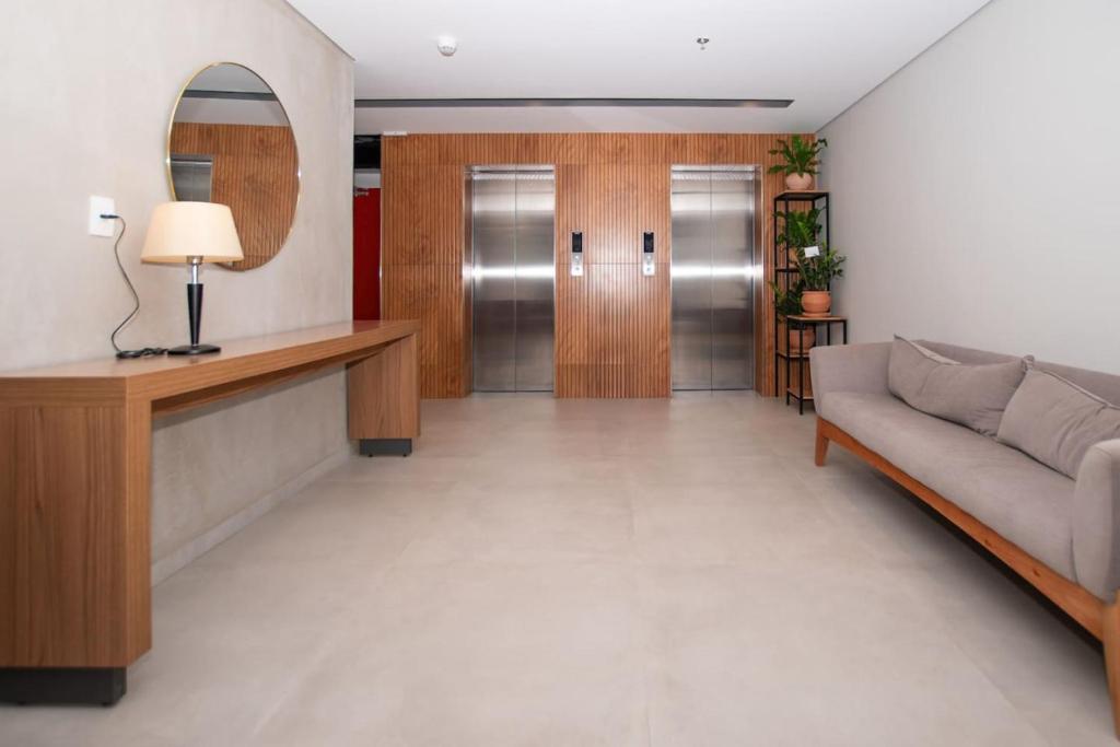 a living room with a couch and a mirror at Stylish 2BR Apt in Top Location in Asunción