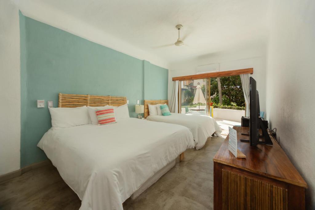 Postel nebo postele na pokoji v ubytování Hotel Amaca Puerto Vallarta - Adults Only