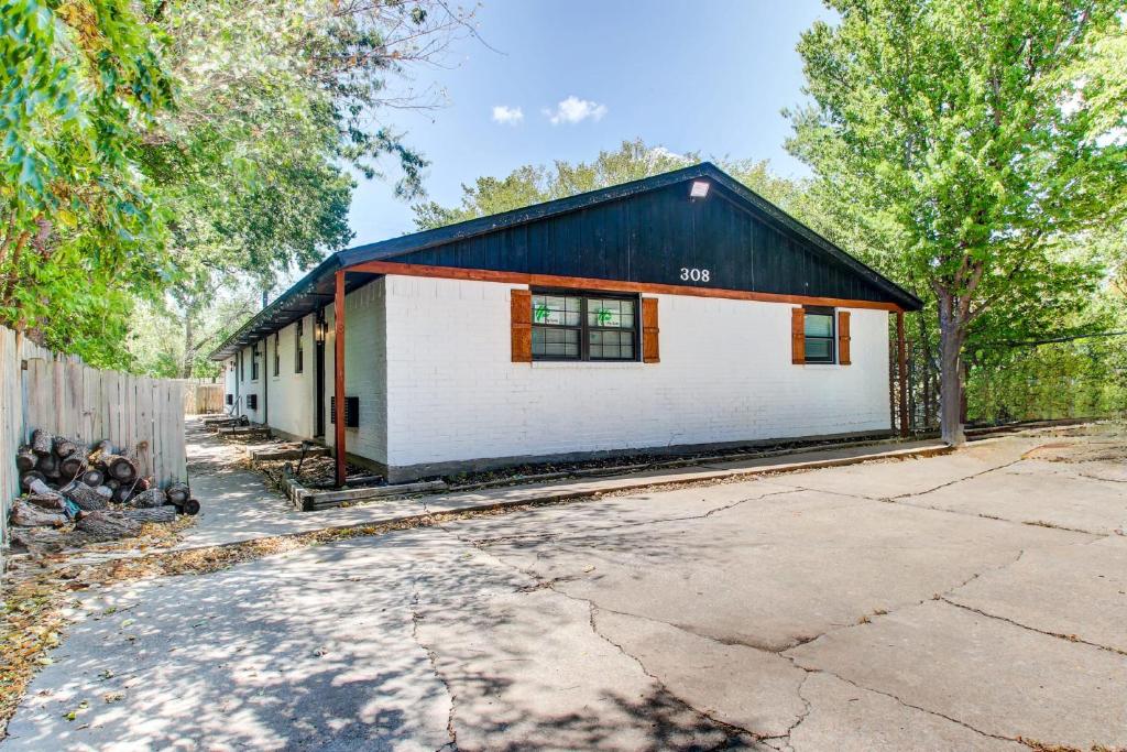 a home with a black and white building at Cozy Home Near Downtown Lawton in Lawton