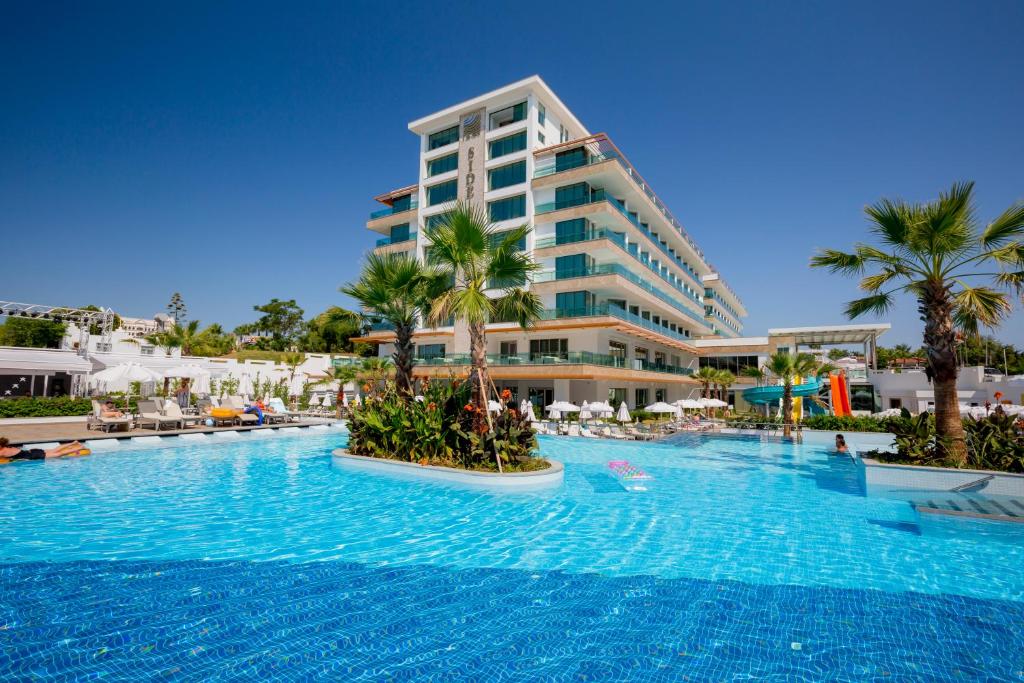 a large swimming pool in front of a hotel at Side Sunport Hotel - All Inclusive in Side