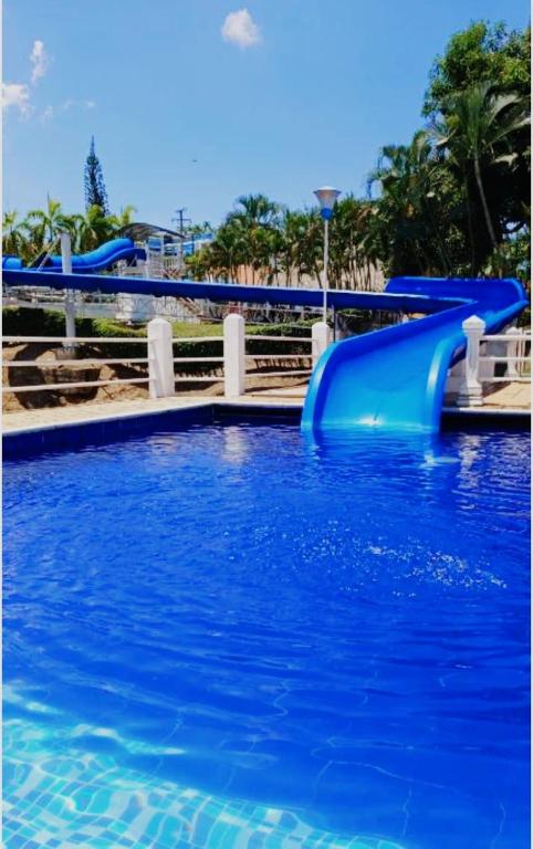 a blue water slide in a swimming pool at Apartamento Melgar, Villa Flórez in Melgar
