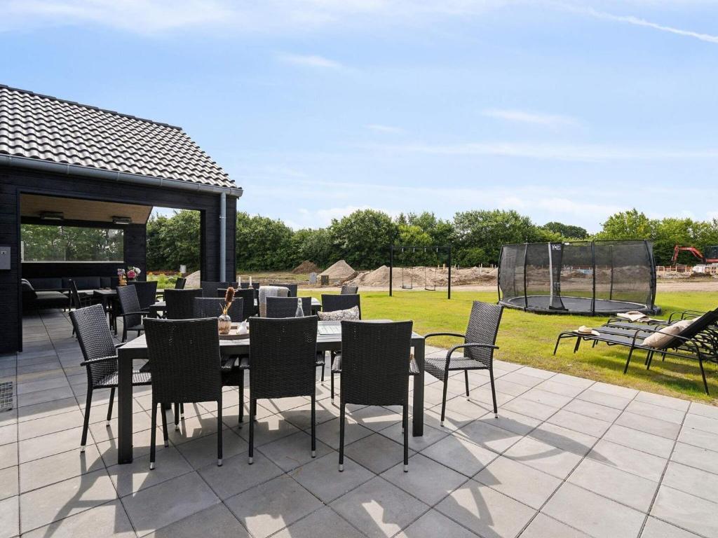 a patio with a table and chairs on a patio at Spacious Retreat near Beach - By Traum Ferienwohnungen in Sarup