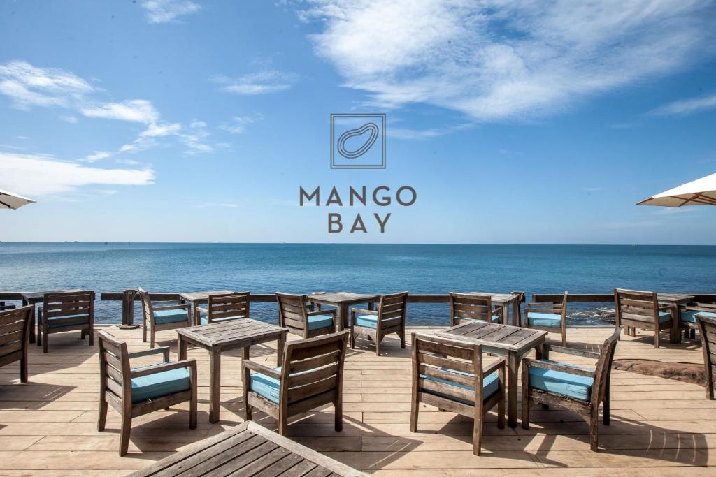 a group of tables and chairs on the beach at Mango Bay Resort in Phú Quốc