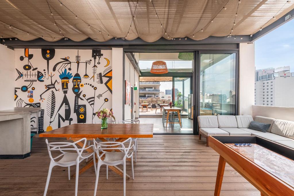 a living room with a table and a couch at Triver Coliving in Mexico City
