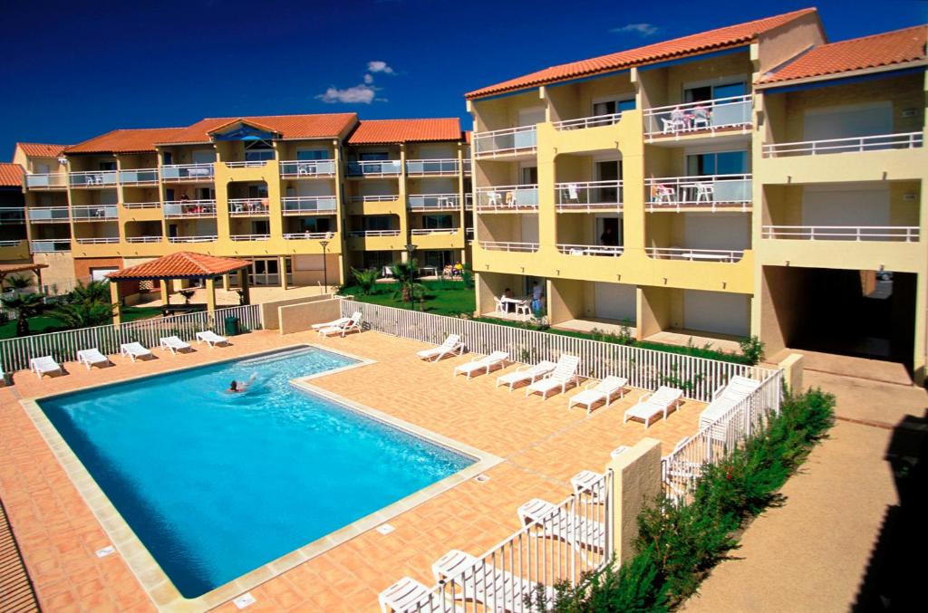  Elle offre une vue aérienne sur un hôtel doté d'une piscine. dans l'établissement Vacancéole - Résidence Alizéa Beach, à Valras-Plage
