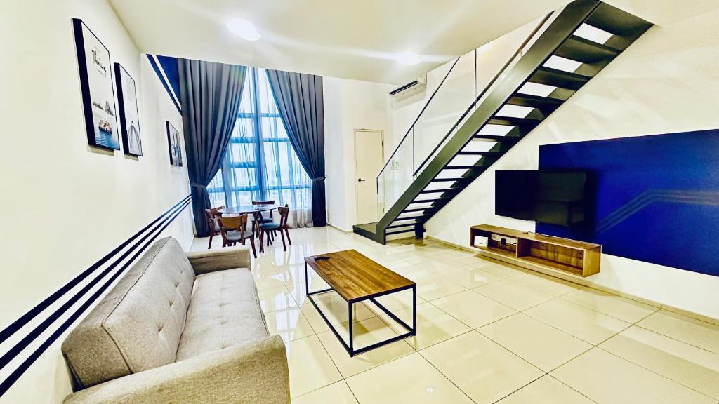 a living room with a couch and a table at EkoCheras Suites, Kuala Lumpur 1-4 Pax in Kuala Lumpur