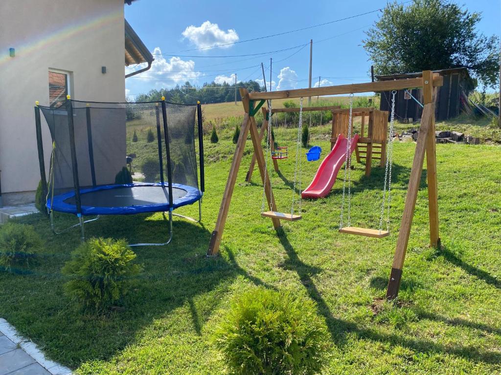 a playground with a swing set in a yard at Ena lux Divčibare in Divčibare