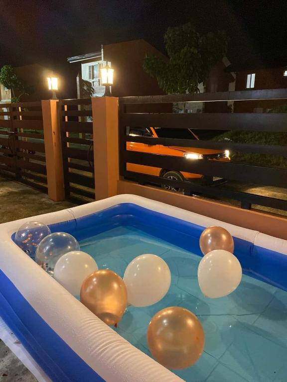 a pool with a bunch of balls in the water at JM Transient House in Butuan