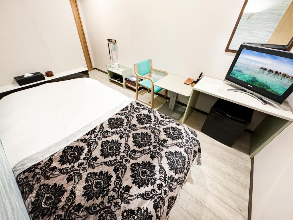 Postel nebo postele na pokoji v ubytování Hotel BaliBali Matsudo