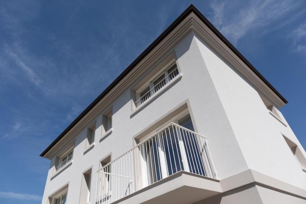 a white building with a balcony on top of it at Riviera Venice Apartments in Mira