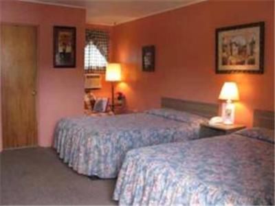 a hotel room with two beds and two lamps at Four Seasons Motel in Catskill