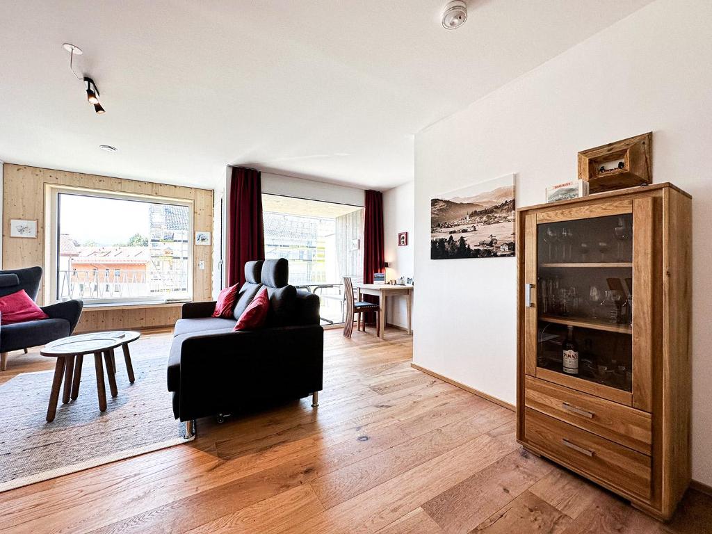 a living room with a couch and a table at Staufner Maisonette in Oberstaufen