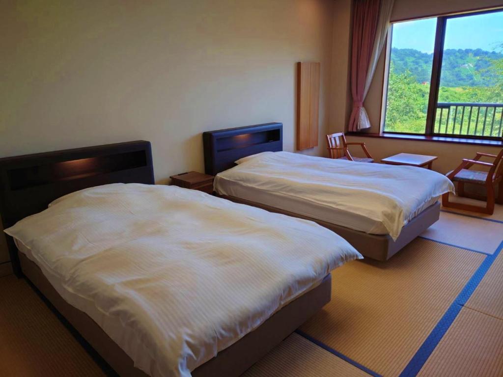 Postel nebo postele na pokoji v ubytování Sasakura onsen Ryuunso