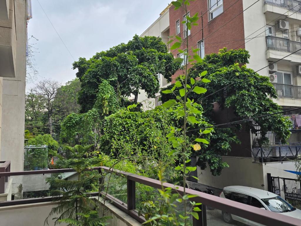 a balcony with a tree in front of a building at Two Green Park in New Delhi