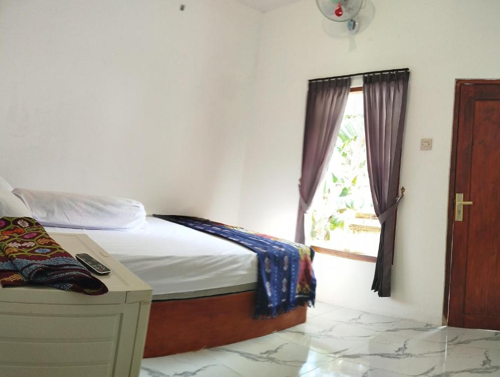Postel nebo postele na pokoji v ubytování Marsha Homestay