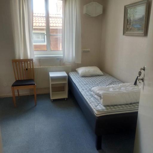Postel nebo postele na pokoji v ubytování Knihsgården