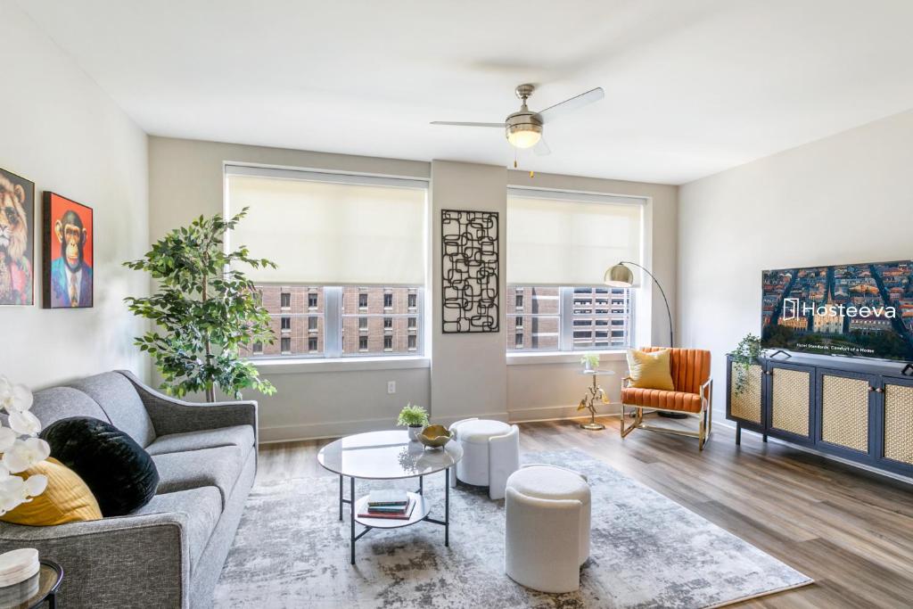 a living room with a couch and a tv at New Renovated Condo in the Heart of NOLA in New Orleans