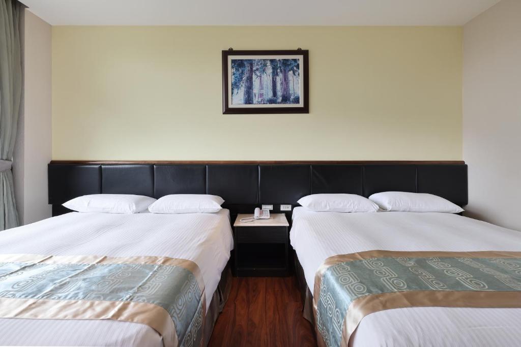 Postel nebo postele na pokoji v ubytování Shante Hotel Shitou