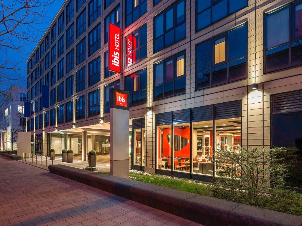 a store front of a building with signs on it at ibis München Parkstadt Schwabing in Munich
