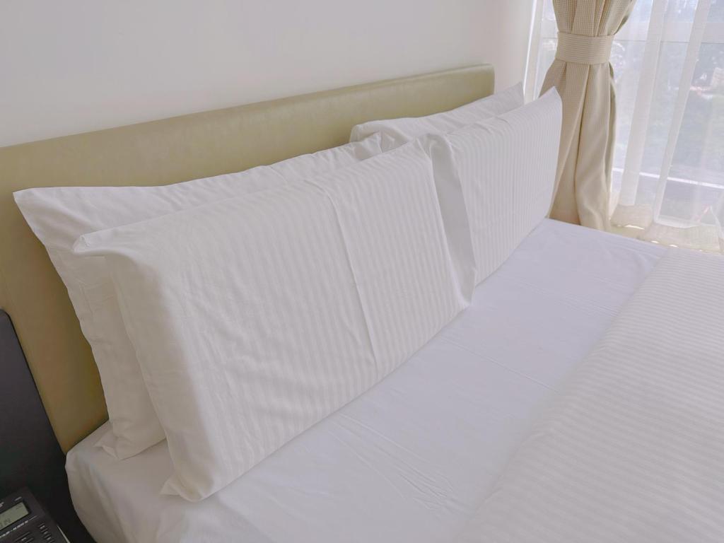 Postel nebo postele na pokoji v ubytování Golden Central Hotel Serviced Residence-Xin Hao E Du金中环服务公寓新浩e都店