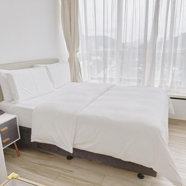 Postel nebo postele na pokoji v ubytování Golden Central Hotel Serviced Residence-Xin Hao E Du金中环服务公寓新浩e都店