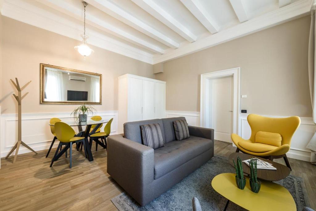 a living room with a couch and a table at Palazzo Bovio - Boutique Apartments in Padova