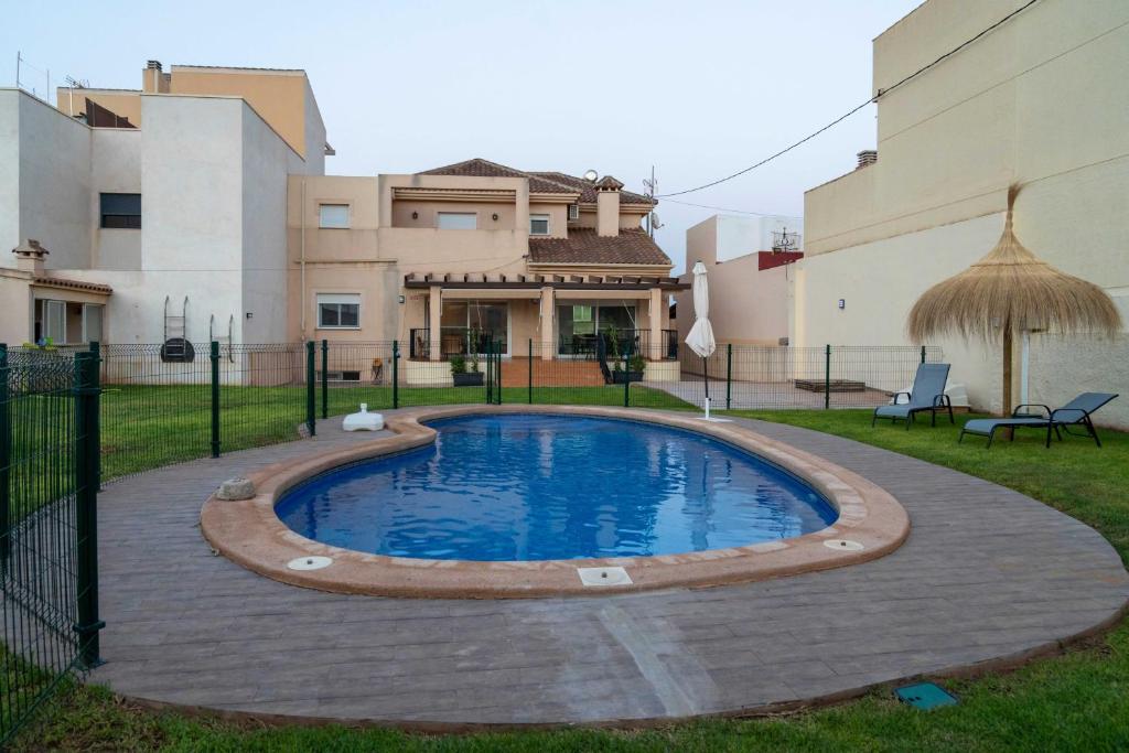 a pool in the yard of a house at Villa Cruceiro in Los Belones