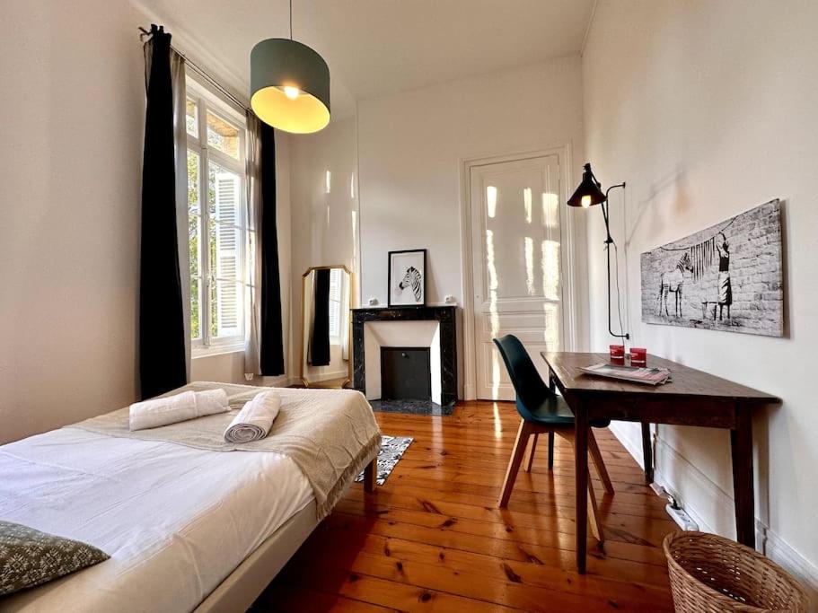 a bedroom with a bed and a desk and a table at Rouen Paris - Domaine de l'Oison 