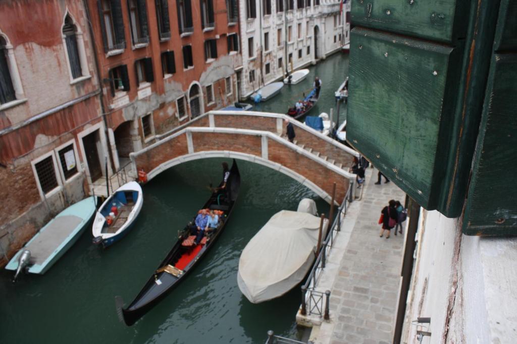 a group of boats in a canal with a bridge at Casa lorenzo in Venice