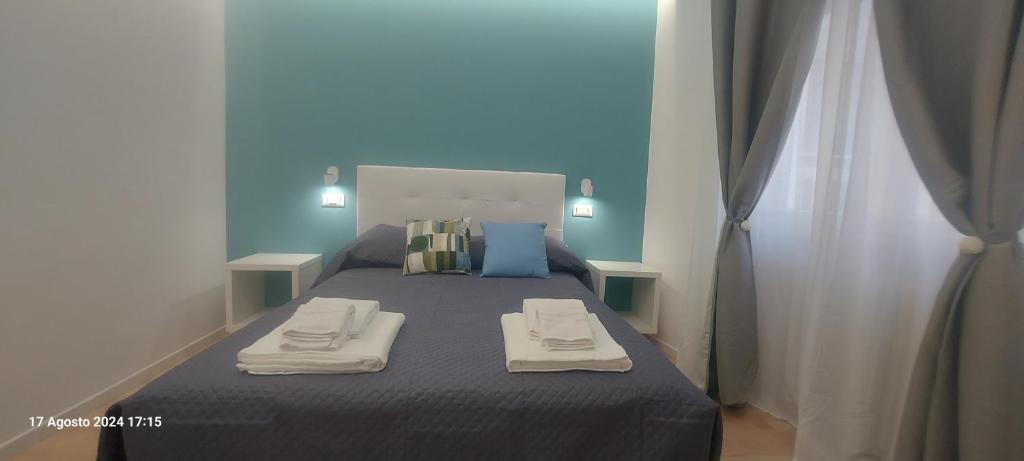 a bedroom with a bed with two towels on it at Bemy in Rome