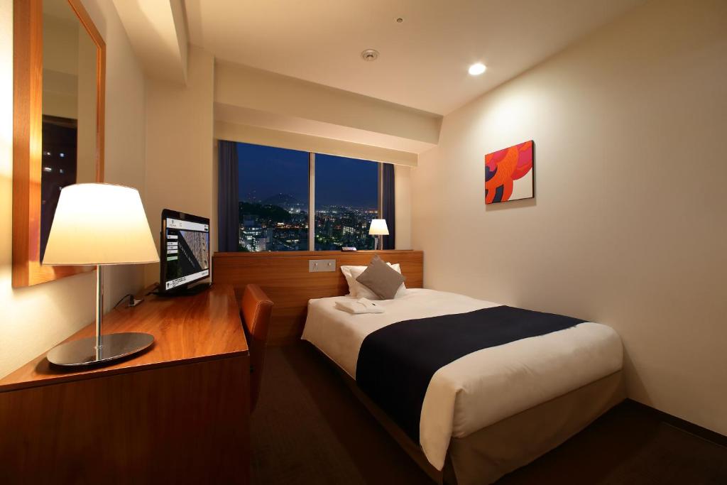 Postel nebo postele na pokoji v ubytování Oriental Hotel Hiroshima