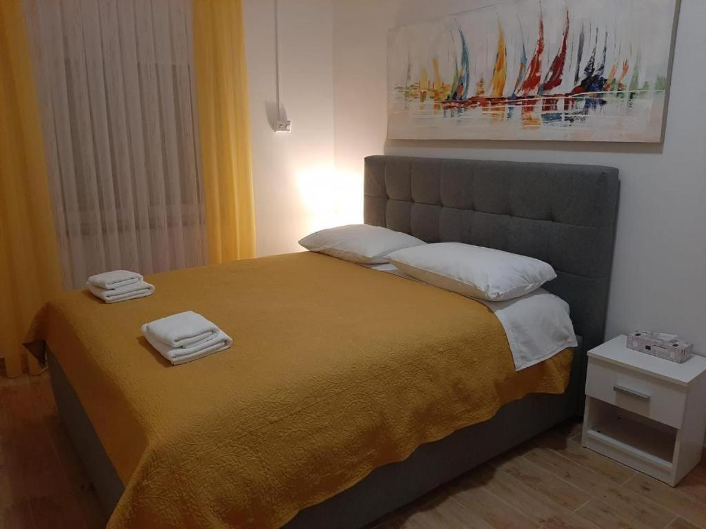 a bedroom with a bed with two towels on it at Guest house Renata 2 in Zadar