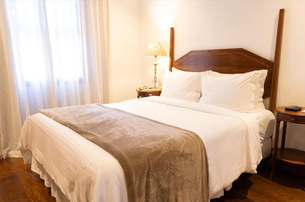 Postel nebo postele na pokoji v ubytování Hotel Solar do Rosário