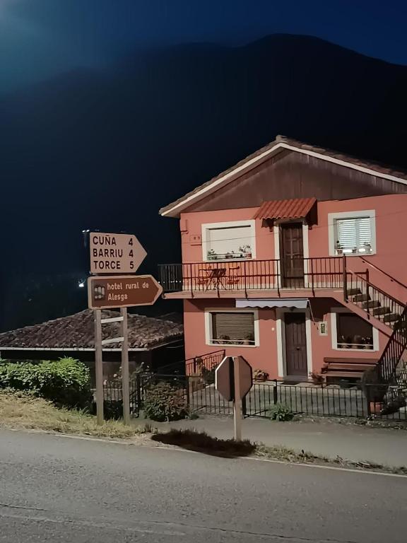 a pink house with a street sign in front of it at San Salvador 11 in La Plaza