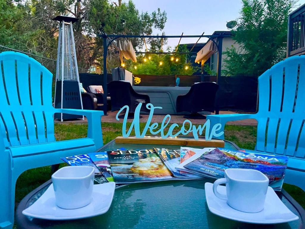 a table with two chairs and magazines on it at Sedona Red Rock Garden of Paradise Pets friendly and Hot tub in Sedona