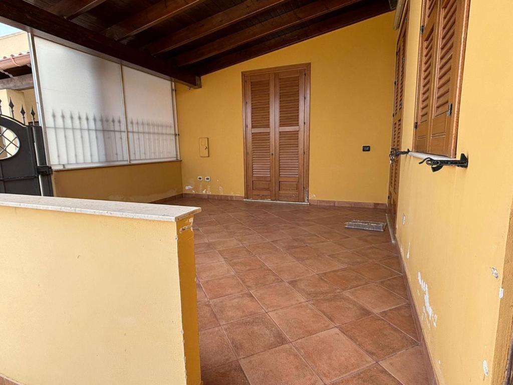 an empty room with yellow walls and a tile floor at Casa vacanza da Maria in Petrosino