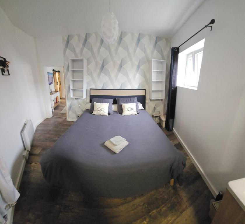 a bedroom with a large bed with two pillows at Jolilina in Mirebeau