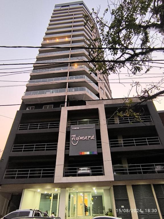 a tall building with a sign in front of it at Departamento con Vista al Río in Posadas