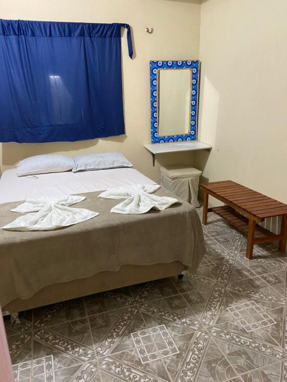 a bedroom with a bed with a mirror and a table at Casamarias duplo in Barra Grande