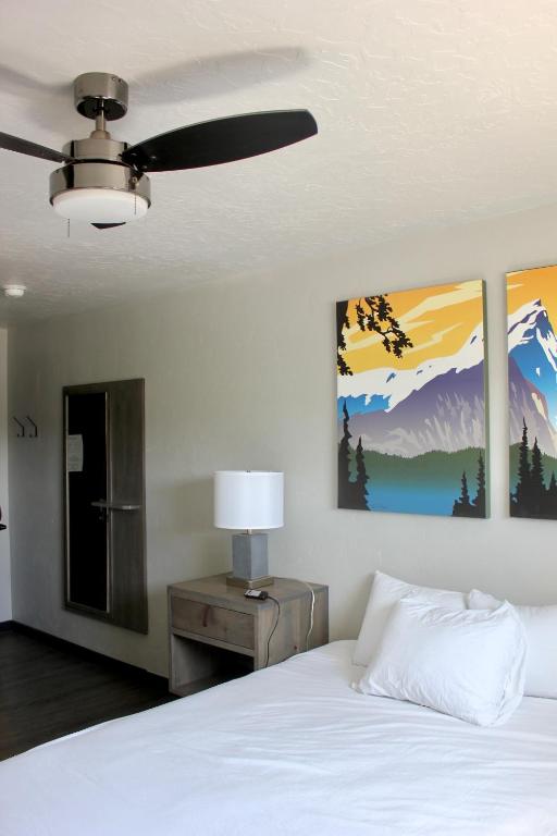 a bedroom with a bed and two paintings on the wall at Palooza Basecamp in Cascade