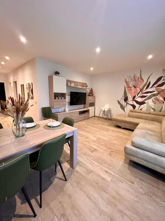 a living room with a table and a couch at Casa di Chiara Andalo Centro in Andalo