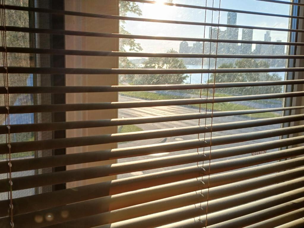 a window with wooden blinds on it with a view at Waterfront Home Windsor ,Canada in Windsor