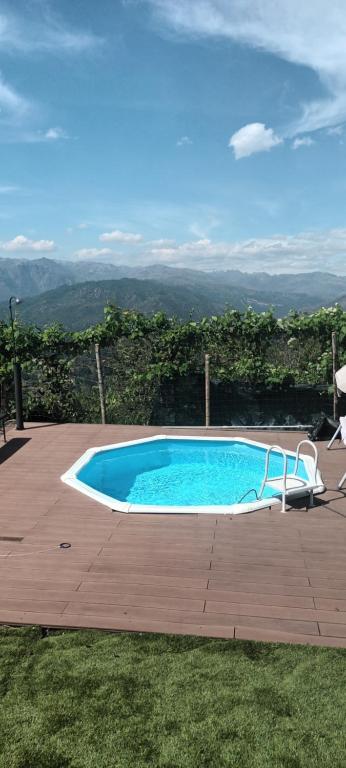 a swimming pool on a wooden deck with a view at Casa com Piscina Privada - Vista Montanhas- Vieira do Minho in Ruivãis