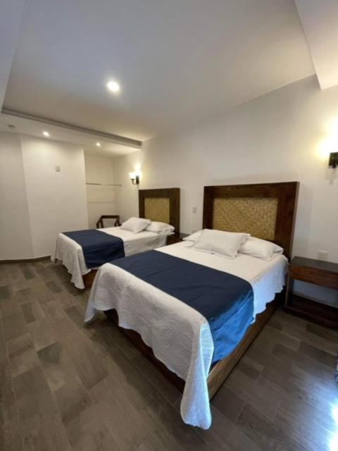 Postel nebo postele na pokoji v ubytování Gran Hotel Yacatas