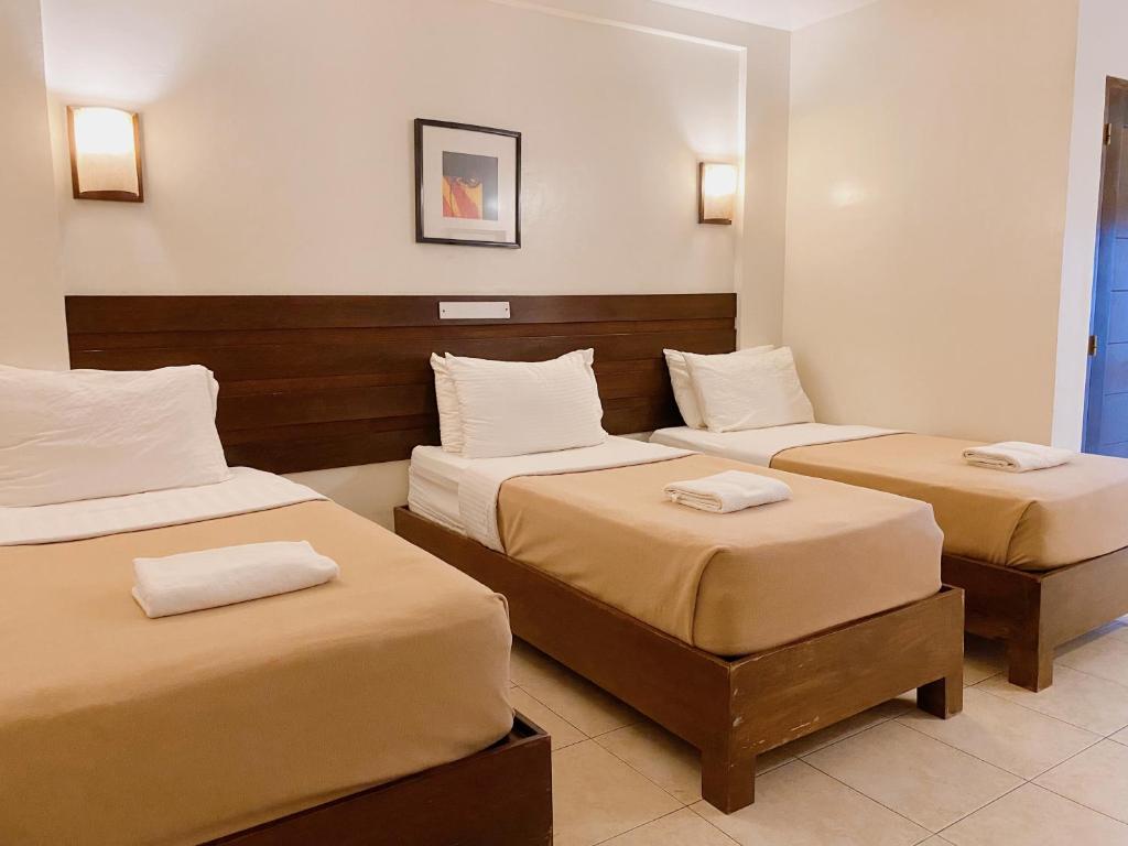 Postel nebo postele na pokoji v ubytování MARZON HOTEL KALIBO