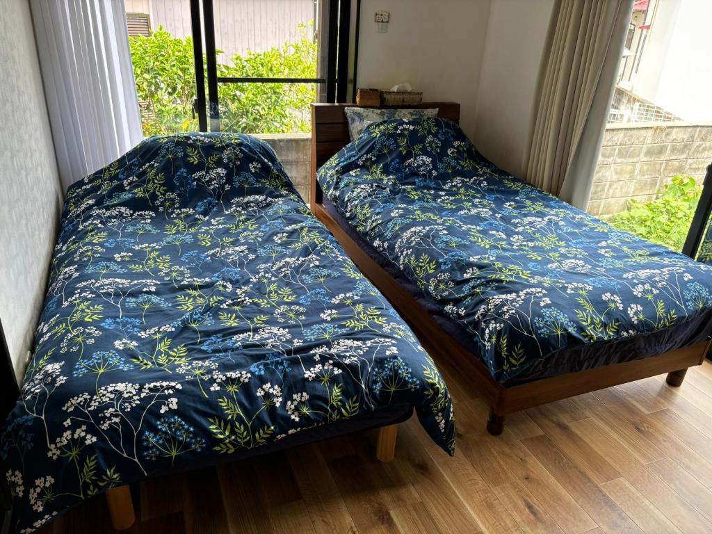 Postel nebo postele na pokoji v ubytování 貸別荘エスポワール浦