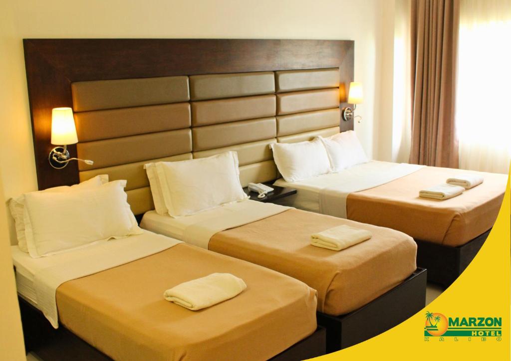 Postel nebo postele na pokoji v ubytování MARZON HOTEL KALIBO